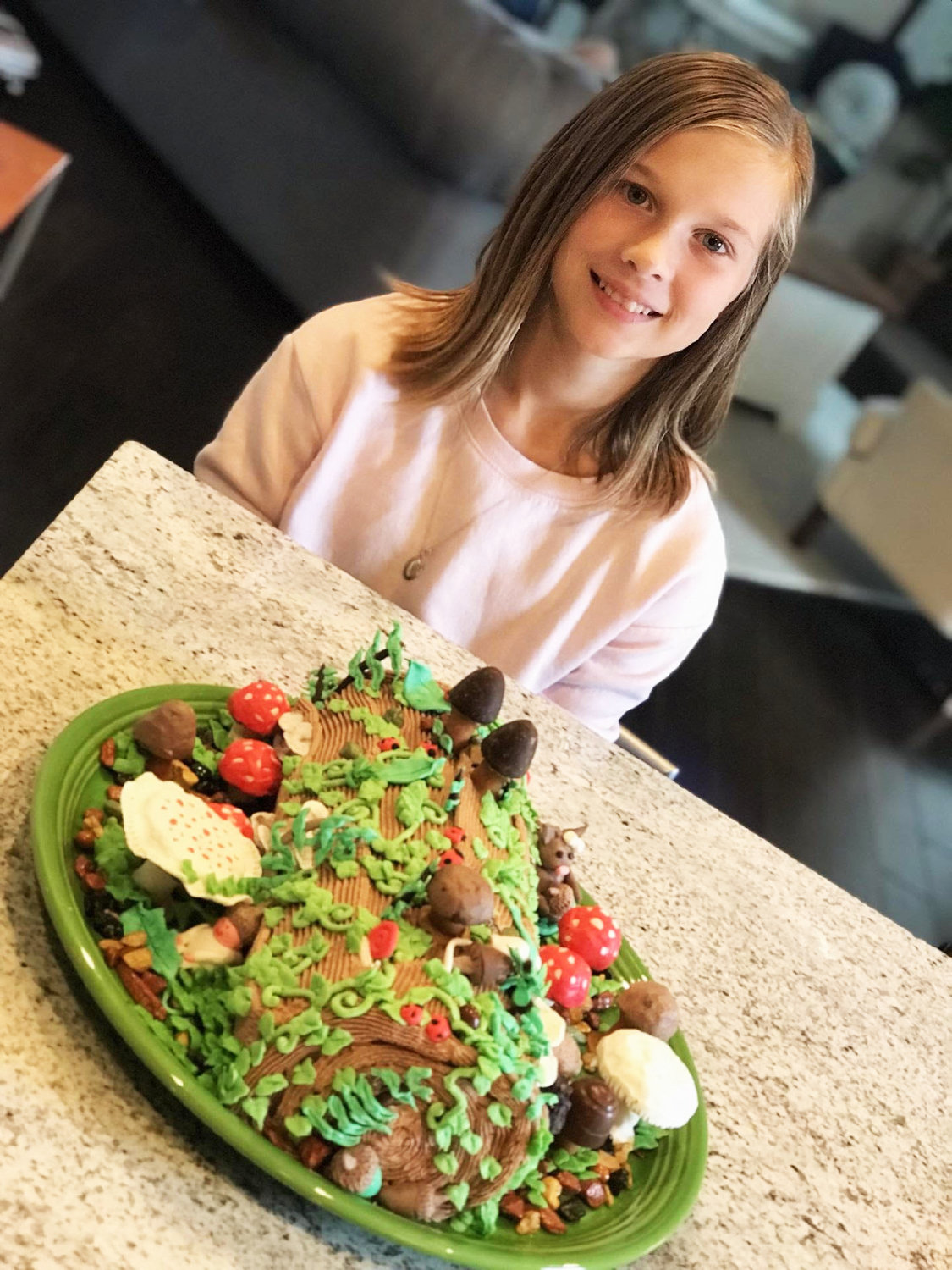 Mia, the granddaughter of Robin Rogers, with the forest cake for her 12th birthday